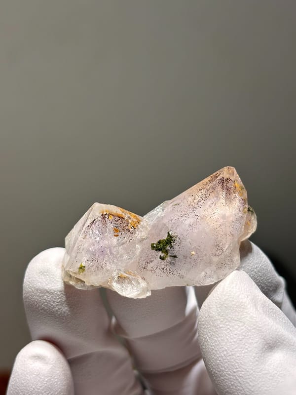 Flat garden quartz with green and orange inclusions from Sichuan, China, close-up of the crystal faces