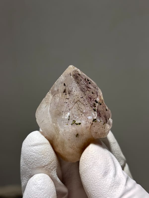 Garden quartz with dark inclusions and rainbow flash from Sichuan, China, close-up of the crystal faces