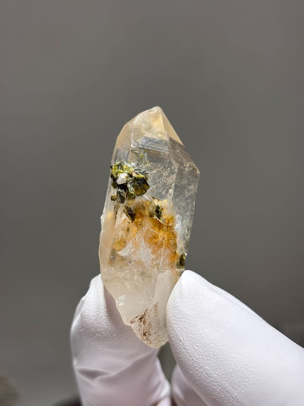 Garden quartz with orange and green inclusions from Sichuan, China, close-up of the crystal faces
