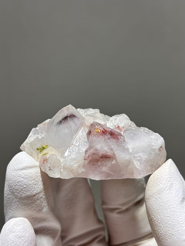 Garden quartz cluster with red and green inclusions from Sichuan, China, close-up of the crystal faces