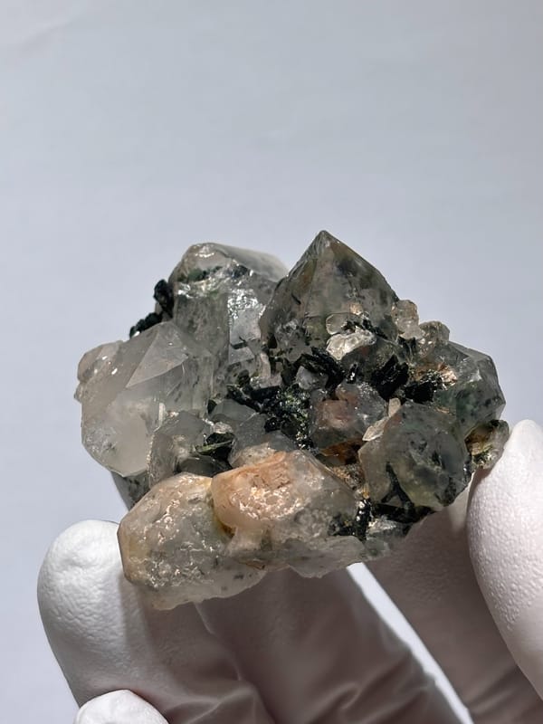 Garden quartz cluster with green inclusions from Sichuan, China, held in hand