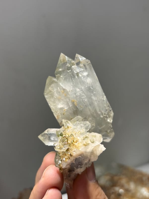 Garden quartz cluster with complete main crystal from Sichuan, China, held in hand