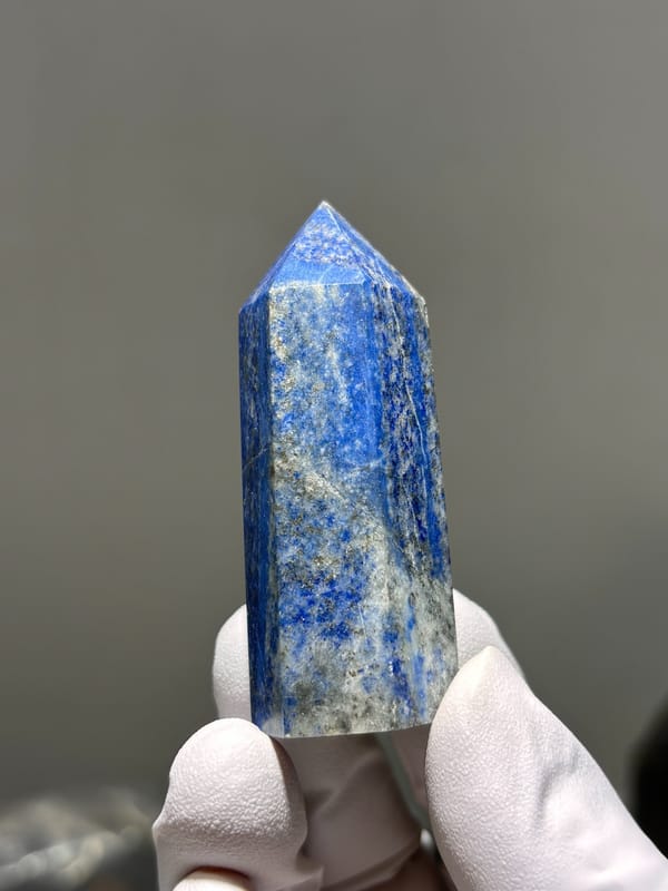 Polished lapis lazuli point with pyrite flecks from Afghanistan, second angle