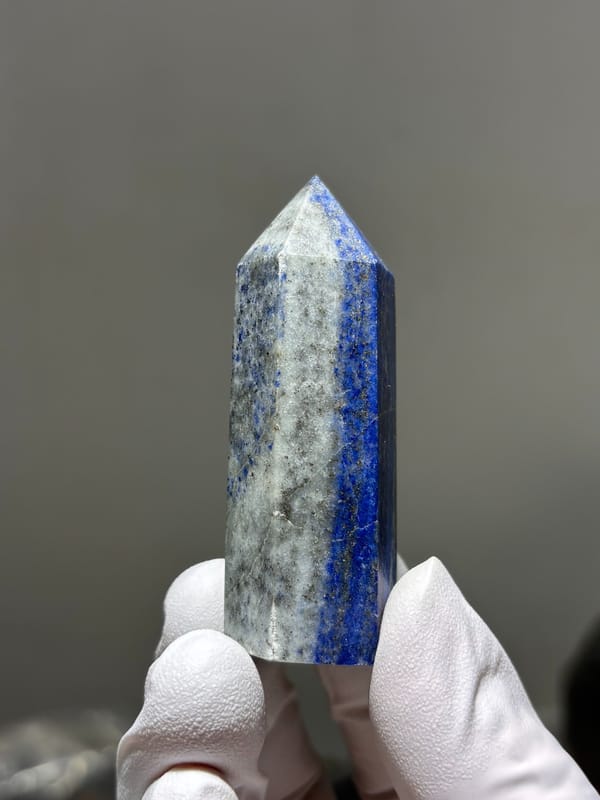 Polished lapis lazuli point with pyrite flecks from Afghanistan, reverse side