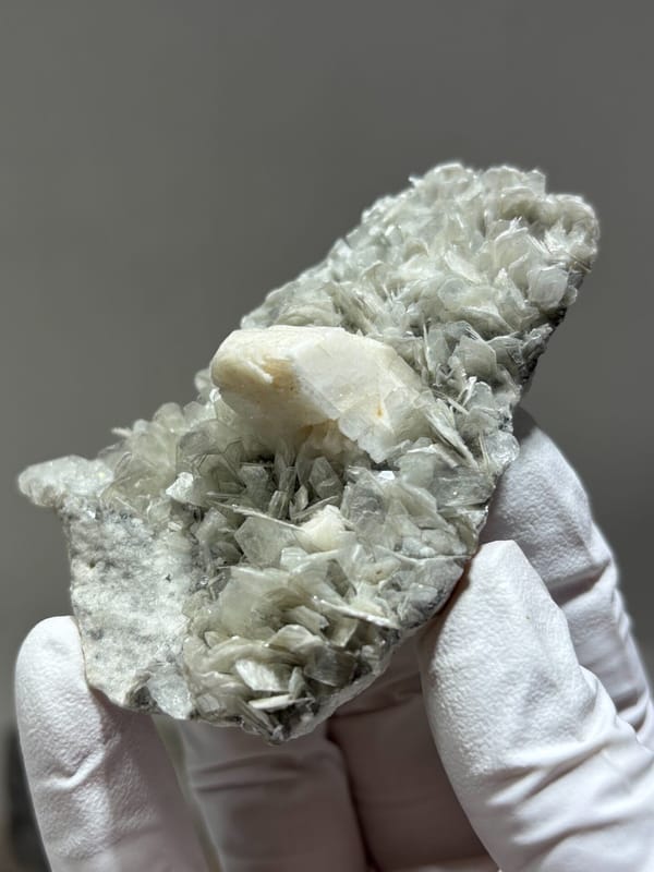 Pale mica plate with feldspar and hidden aquamarine from Xuebaoding, Sichuan, China, reverse side