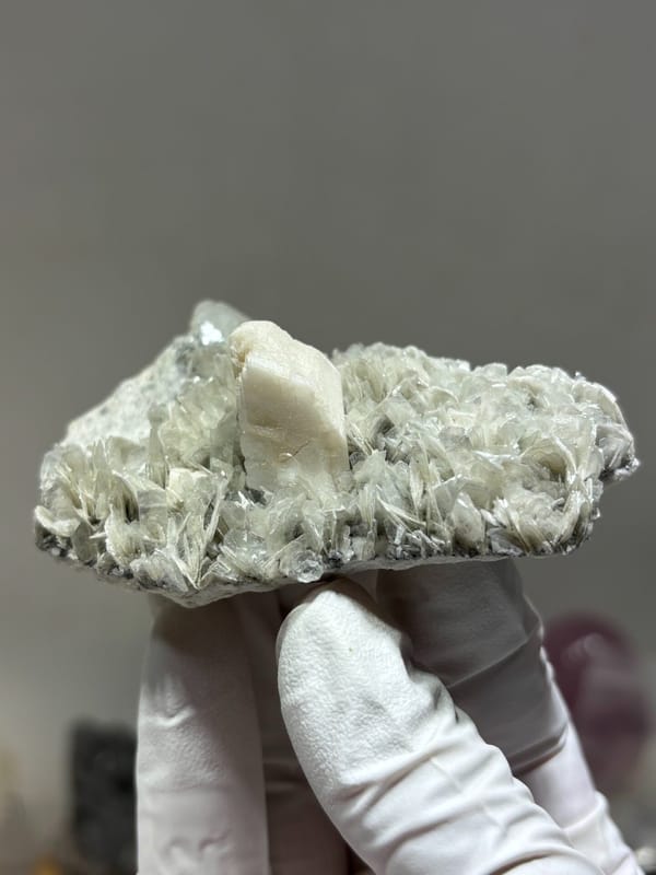 Pale mica plate with feldspar and hidden aquamarine from Xuebaoding, Sichuan, China, top view