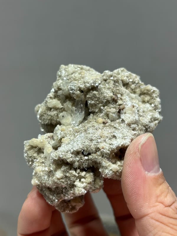 Silvery mica block with small quartz prism and white calcite from Xuebaoding, Sichuan, China, second angle