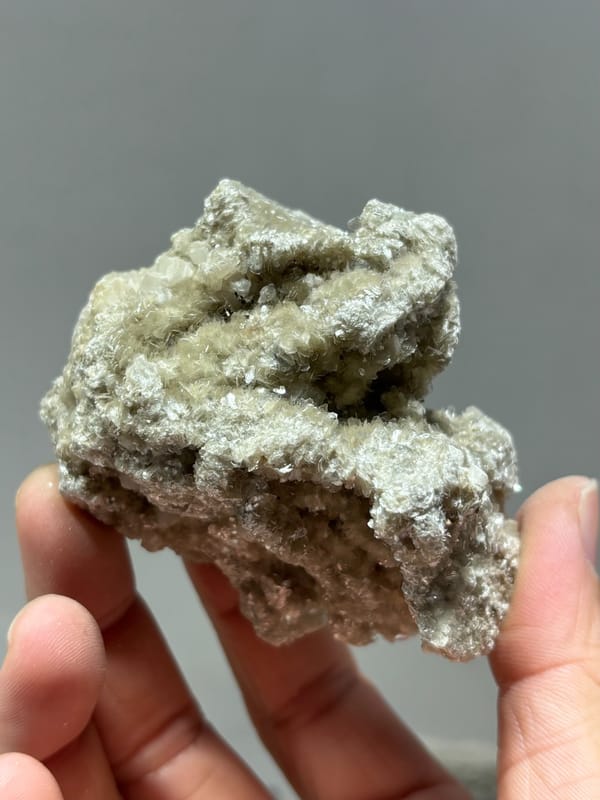 Silvery mica block with small quartz prism and white calcite from Xuebaoding, Sichuan, China, reverse side