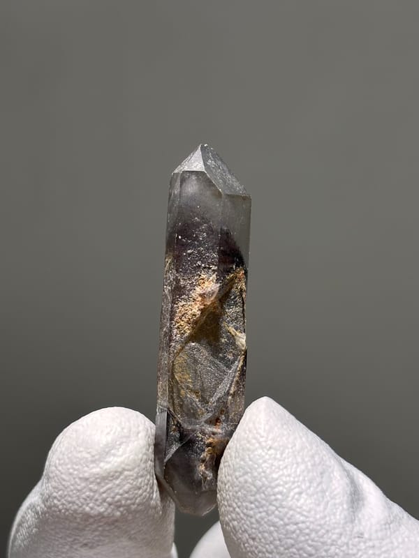 Slender red phantom quartz wand from Brazil, close-up of the crystal faces