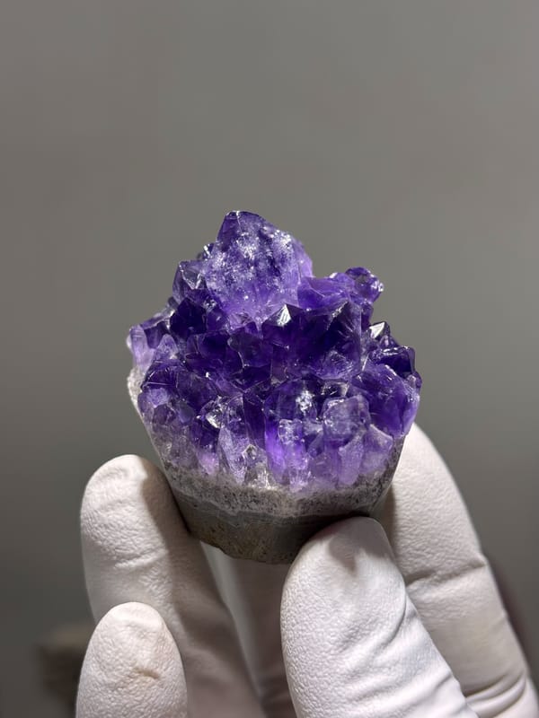 Deep purple amethyst cluster on sawn base from Brazil, close-up of the crystal faces
