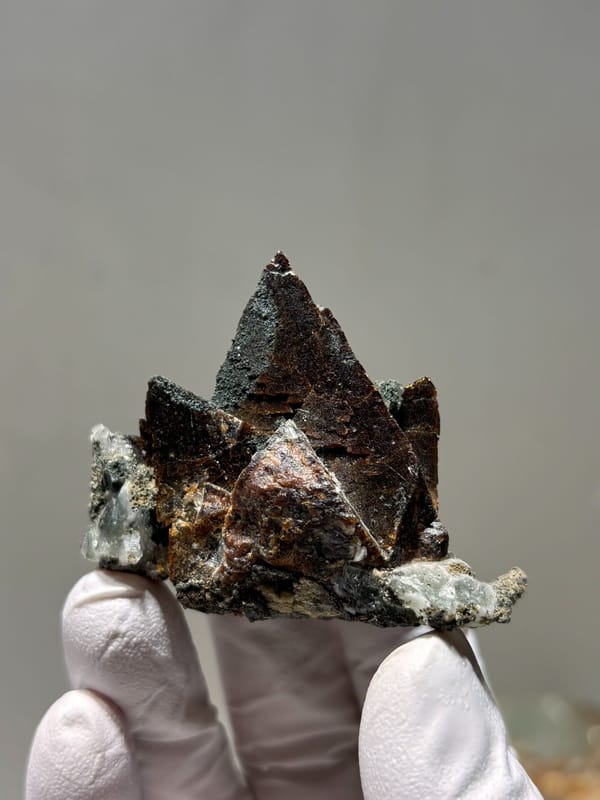 Dark brown helvine crystal group from Inner Mongolia, China, reverse side