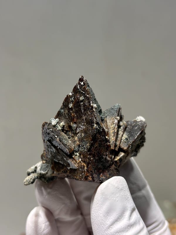Dark brown helvine crystal group from Inner Mongolia, China, detail of the matrix contact