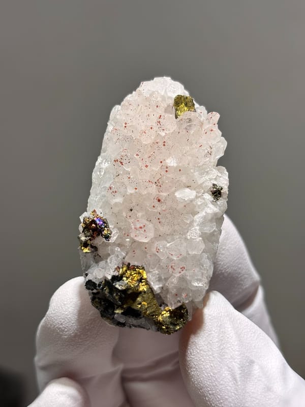 White quartz plate with red specks and chalcopyrite from Jiangxi, China, close-up of the crystal faces