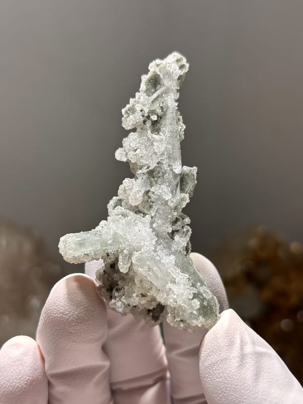 Grey-green botryoidal apophyllite spire over quartz from Hubei, China, close-up of the crystal faces