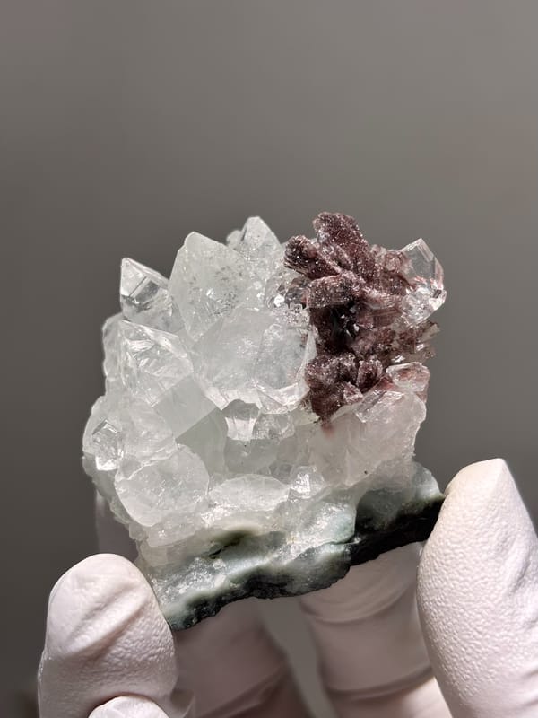 Clear apophyllite crystals with pink-brown cluster from India, second angle
