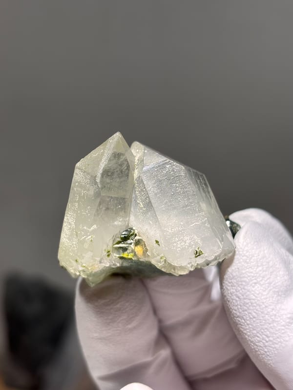 Two clear quartz points with green epidote from Sichuan, China, second angle