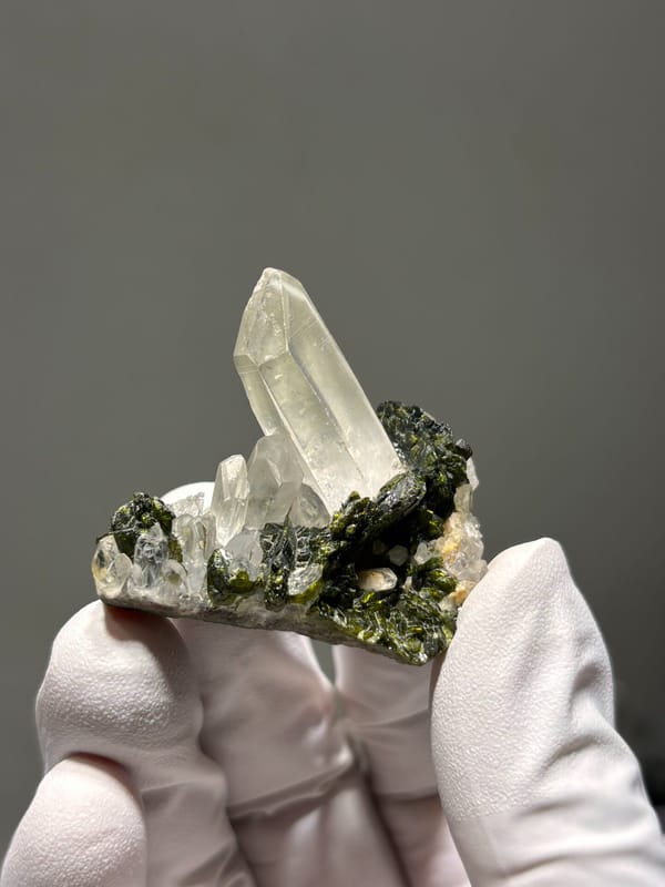 Milky quartz point on green epidote from Sichuan, China, close-up of the crystal faces