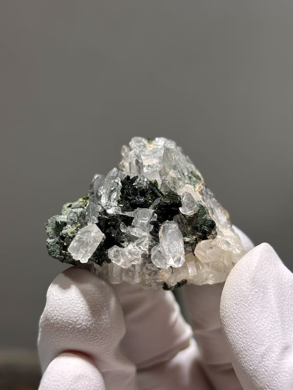 Clear quartz points with dark green epidote from Sichuan, China, close-up of the crystal faces