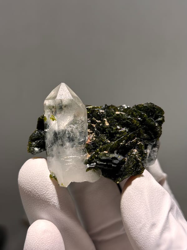 Clear quartz point on dark green epidote from Sichuan, China, second angle