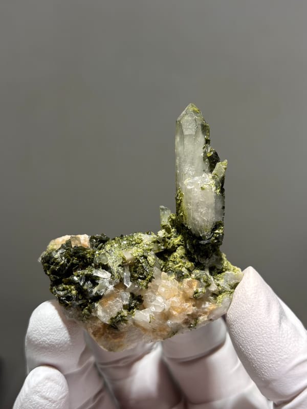 Clear quartz point rising from green epidote from Sichuan, China, second angle