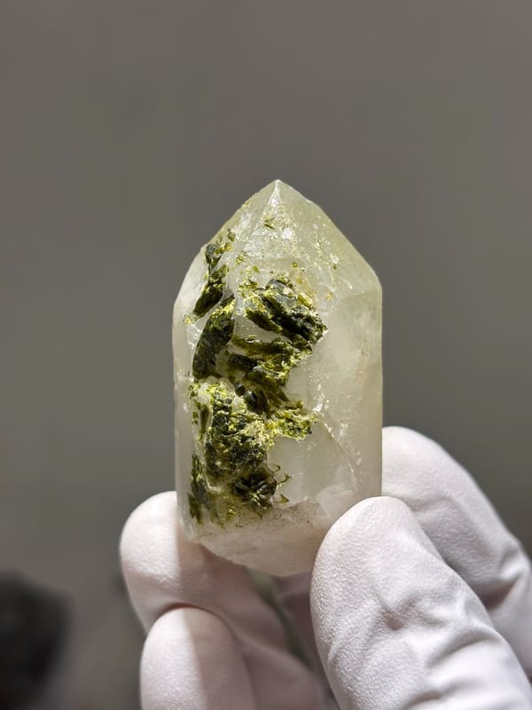 Milky quartz point with green epidote on its face from Sichuan, China, second angle