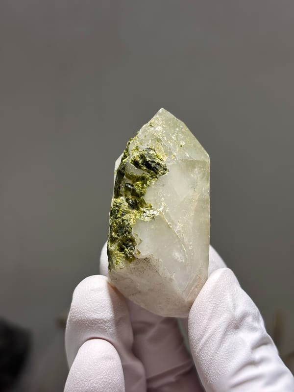 Milky quartz point with green epidote on its face from Sichuan, China, top view