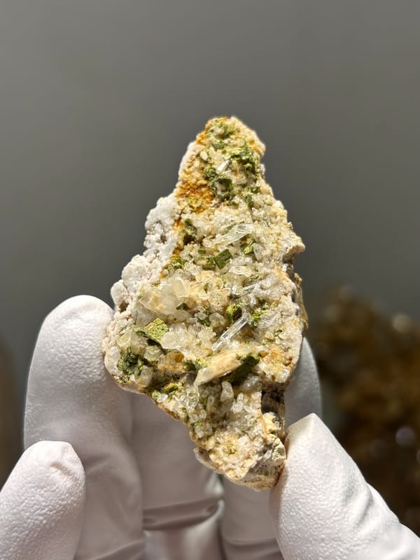 Green epidote in quartz-feldspar slab from Meigu, Sichuan, China, second angle