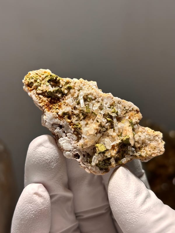 Green epidote in quartz-feldspar slab from Meigu, Sichuan, China, reverse side