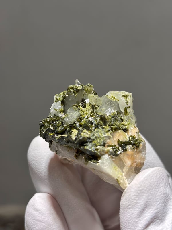 Green epidote with clear quartz on white matrix from Sichuan, China, close-up of the crystal faces