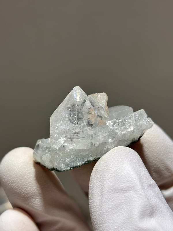 Pale green apophyllite cluster with zeolite spray from India, close-up of the crystal faces