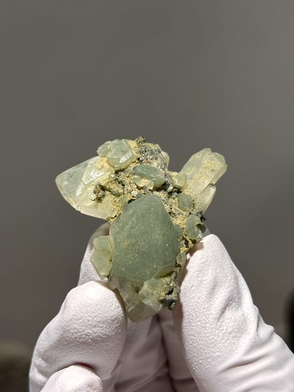 Pale green epidote-tinted quartz points from Sichuan, China, close-up of the crystal faces