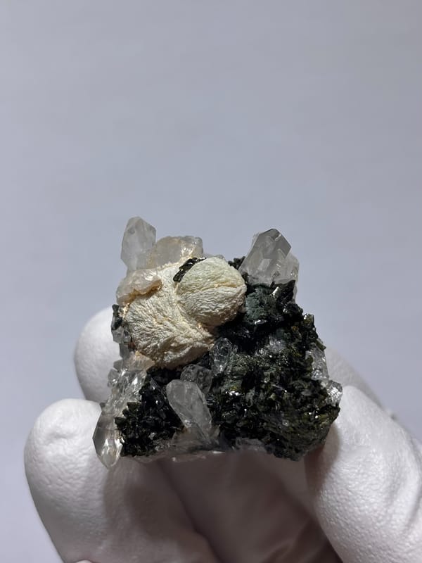 Pale green prehnite ball with quartz and dark epidote from Yunnan, China, second angle