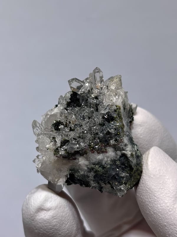 Pale green prehnite ball with quartz and dark epidote from Yunnan, China, reverse side