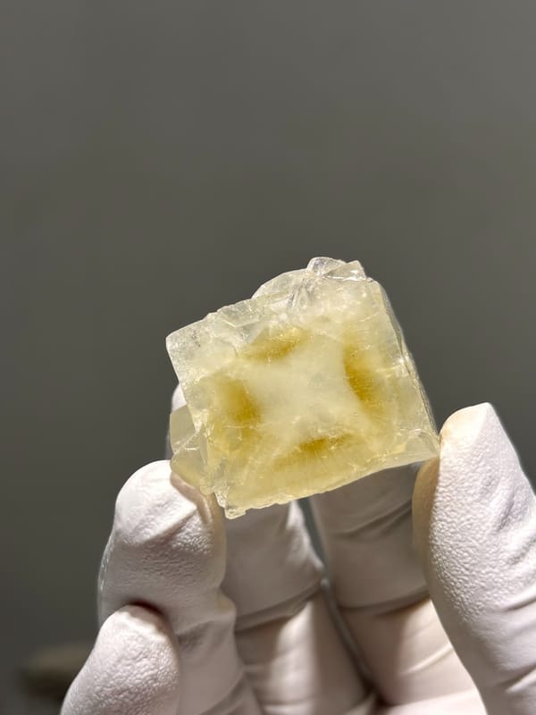 Pale yellow apophyllite cube with hourglass pattern from India, reverse side