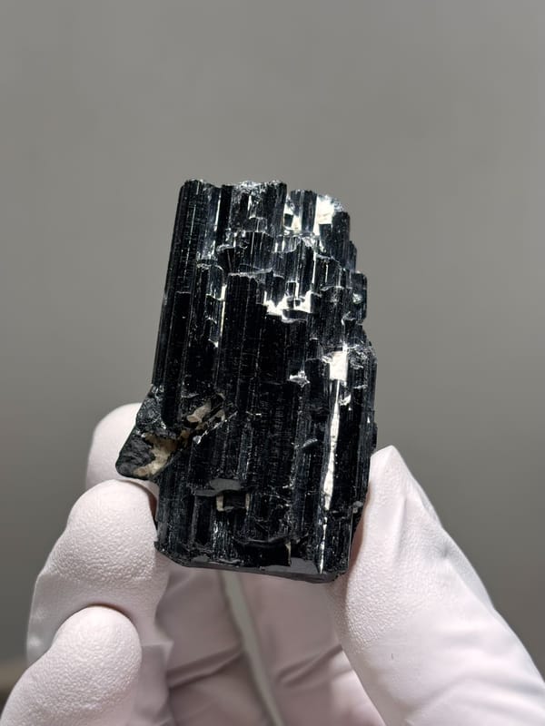 Glossy black schorl cluster from Mozambique, close-up of the crystal faces