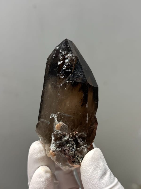 Dark smoky quartz point with complete tip from Fujian, China, close-up of the crystal faces