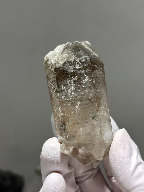 Smoky quartz floater with sharp termination from Sichuan, China, close-up of the crystal faces