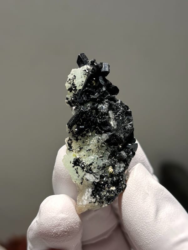 Black babingtonite crystals on pale green prehnite from Yunnan, China, second angle