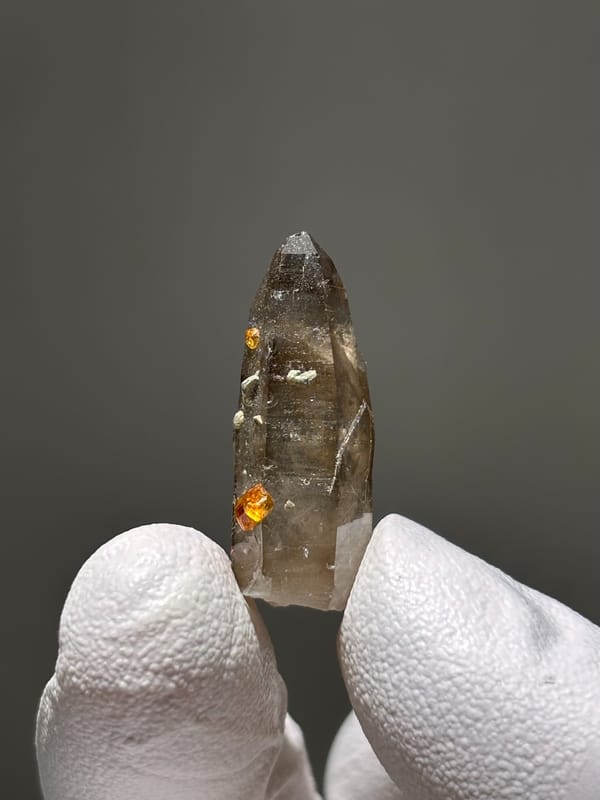 Tiny smoky quartz with Fanta-orange spessartine from Fujian, China, top view