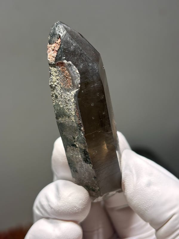 Smoky quartz point with grey phantom from Fujian, China, close-up of the crystal faces