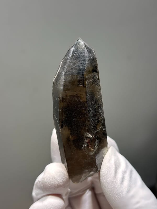 Smoky quartz point with grey phantom from Fujian, China, top view