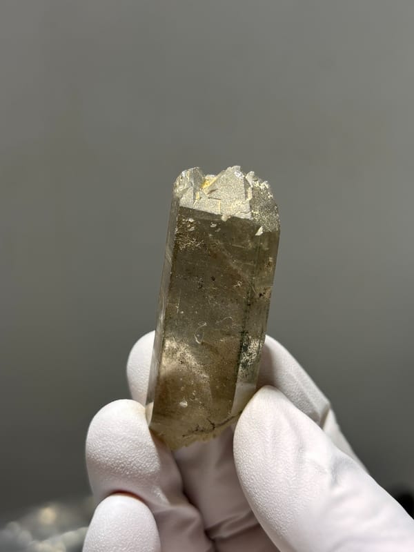 Tea-brown smoky quartz point with milky tip from Sichuan, China, reverse side