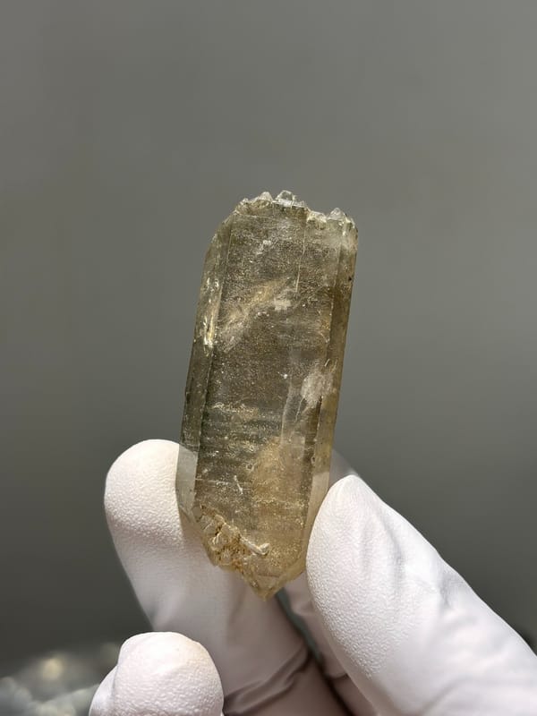 Tea-brown smoky quartz point with milky tip from Sichuan, China, top view