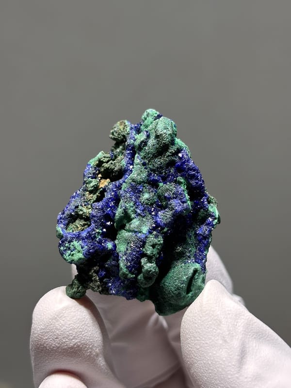Deep blue azurite crust with green malachite from Hubei, China, close-up of the crystal faces
