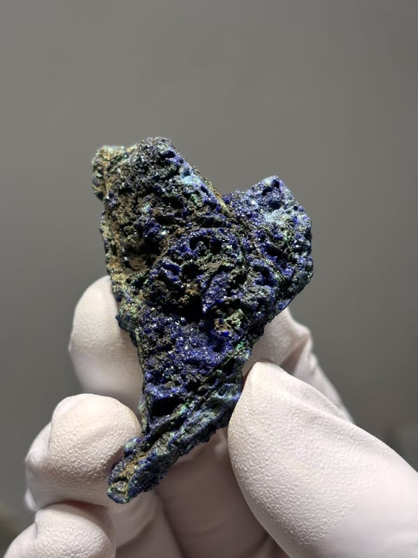 Deep blue azurite plate with green malachite spots from Hubei, China, close-up of the crystal faces