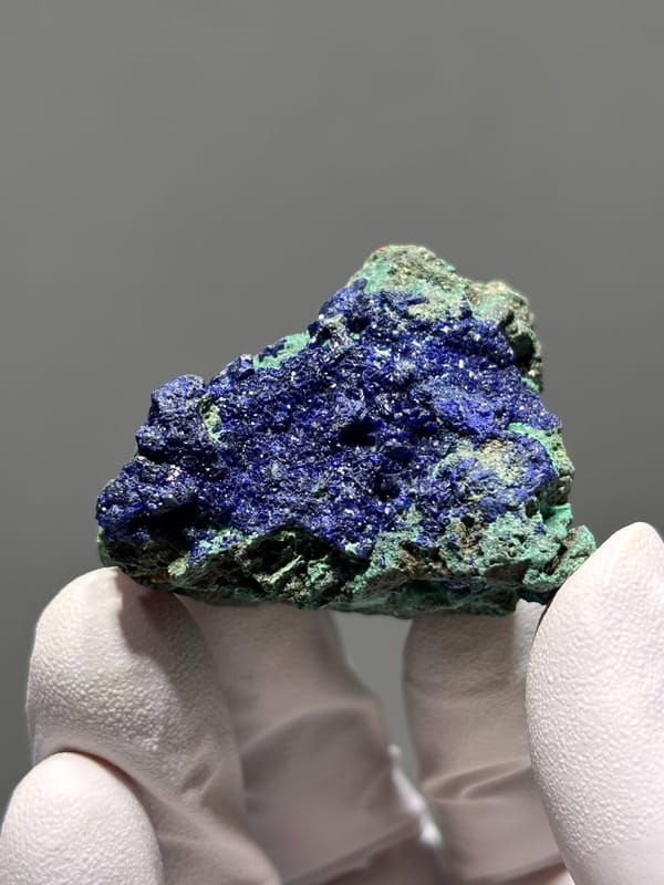 Sparkling azurite crust with green malachite from Hubei, China, close-up of the crystal faces
