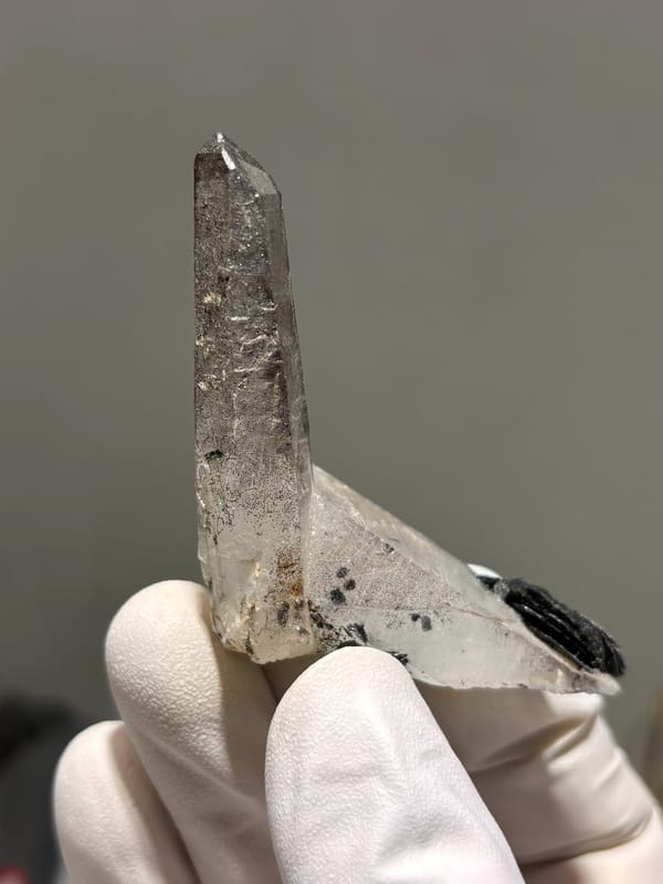 Smoky quartz point on specular hematite base from Guangdong, China, reverse side