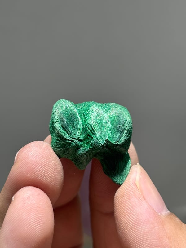 Tiny velvet malachite nodule with silky sheen from Guangdong, China, close-up of the crystal faces