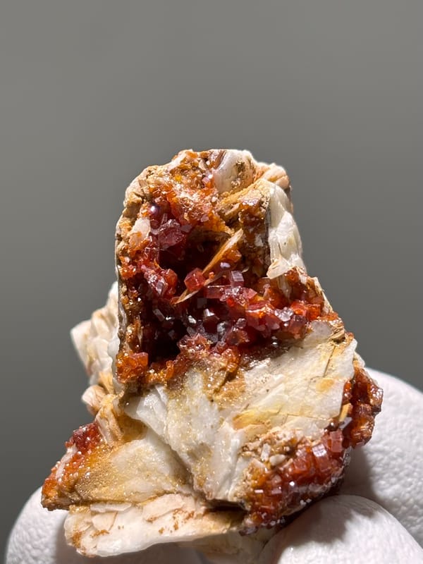 Red vanadinite crystals on white baryte from Morocco, reverse side