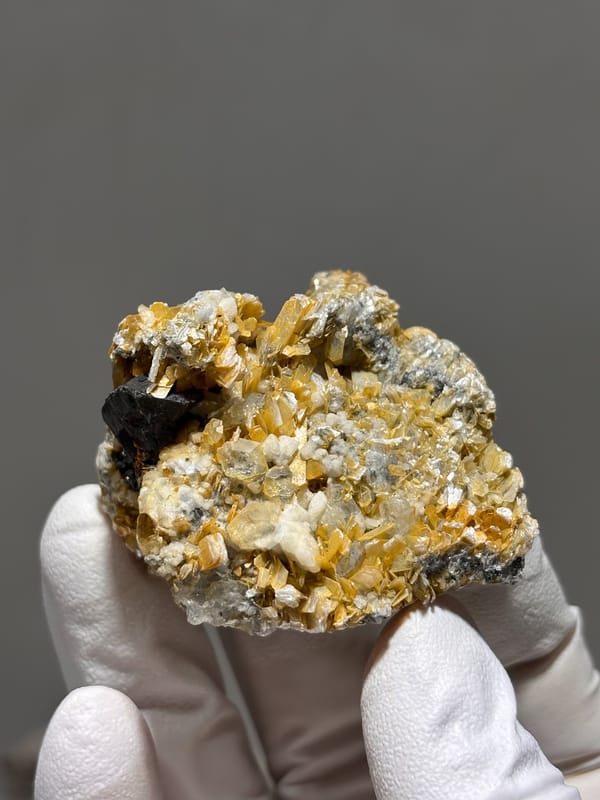 Black cassiterite crystal with aquamarine and mica from Xuebaoding, Sichuan, China, second angle